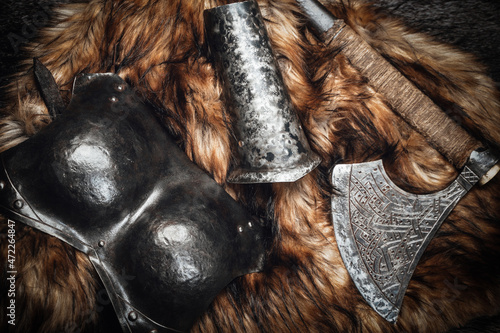 Shot of scandinavian armored suit and axe on fur © Fxquadro