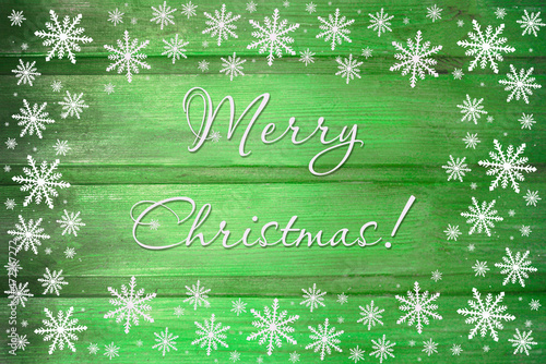 Winter wooden green yellow nature background with snowflakes around. Texture of painted wood horizontal boards. Merry Christmas card.