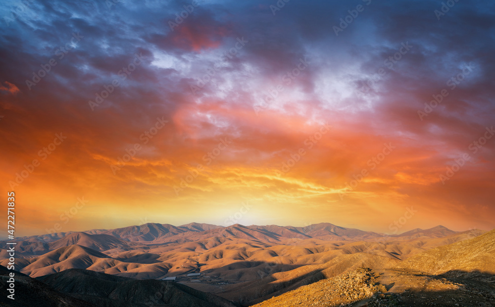 Mountain landscape with orange sky. during sunset