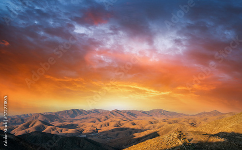 Mountain landscape with orange sky. during sunset