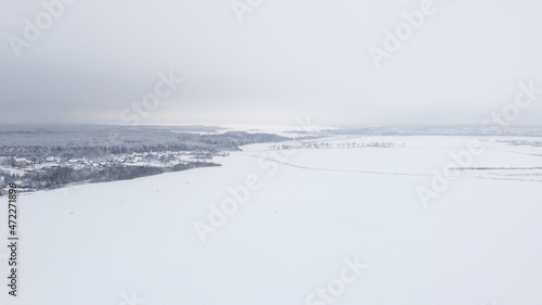 Aerial view of the winter landscape. White fields and meadows of nature