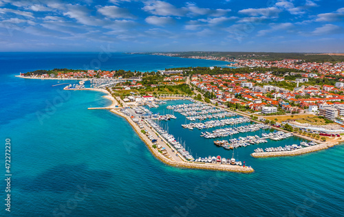 Zadar, Croatia - Aerial view of Zadar yacht marina with sailboats, yachts, blue sky and turquoise Adriatic sea water on a sunny summer day photo