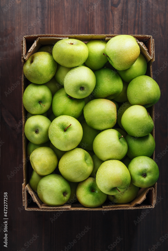 Ripe and juicy Green apples in a box on a wooden table. Ripe and juicy Green apples in a box on a wooden table.