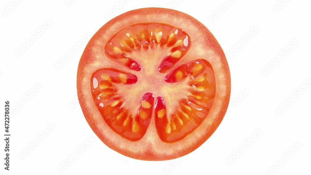 Tomato cut, middle close-up, rotating on white background, top view. Tomato cut, middle close-up, rotating on white background, top view.