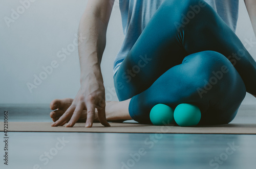 Obraz na plátně Person doing yin yoga and myofascial release on shin muscle