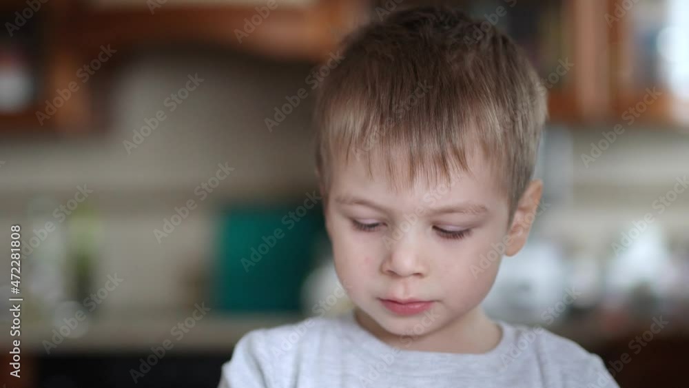 A sick child licks his fingers in sour cream A sick child licks his fingers in sour cream