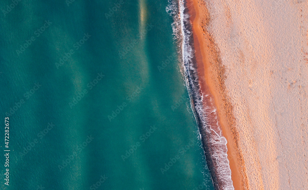 Aerial view of seashore and wild sandy beach. Natural background, drone photography. Directly above.