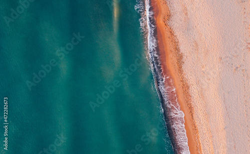 Aerial view of seashore and wild sandy beach. Natural background, drone photography. Directly above.