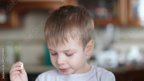 Boy with snot, coughs and eats popcorn