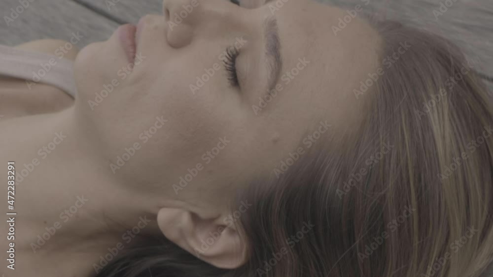A woman lies on the floor and meditates. High quality 4k footage A woman lies on the floor and meditates. High quality 4k footage