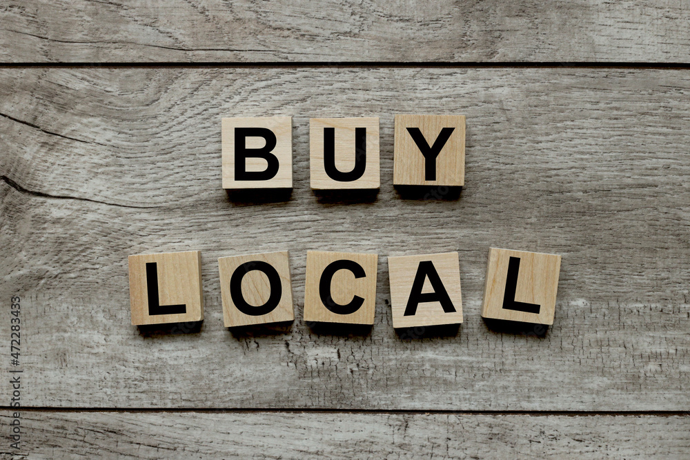 Buy local, text on wooden blocks on a wooden background Buy local, text on wooden blocks on a wooden background