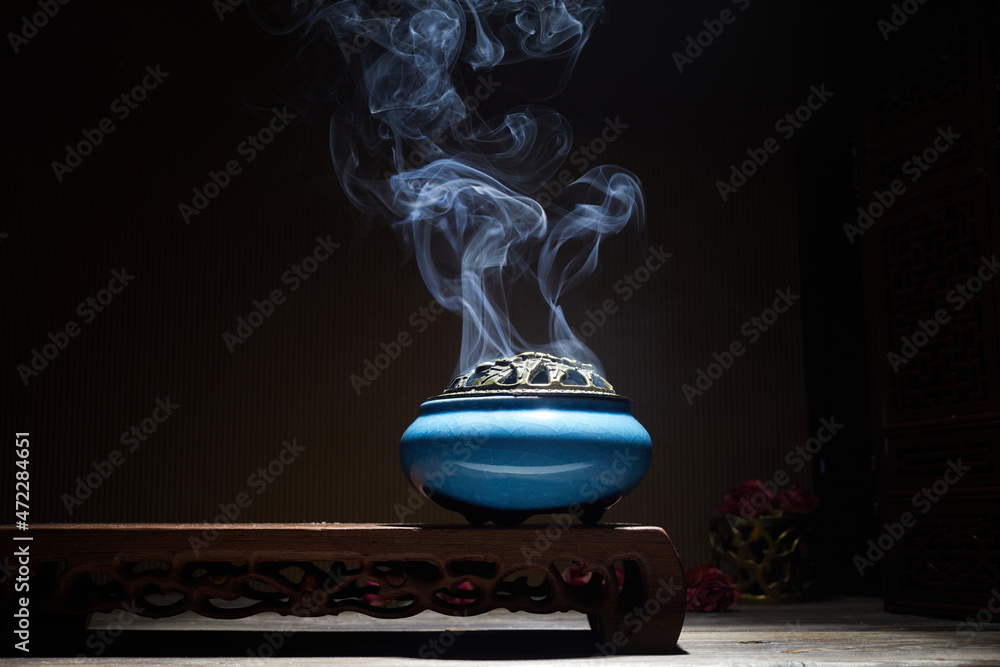 Smoke from burning incense sticks standing on lotus incense holder - obrazy, fototapety, plakaty 