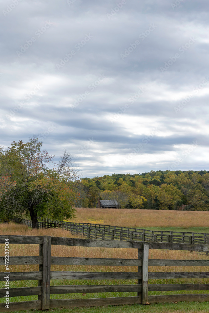 Vertical composition of a barn on a county farm on a cloudy Autumn day.