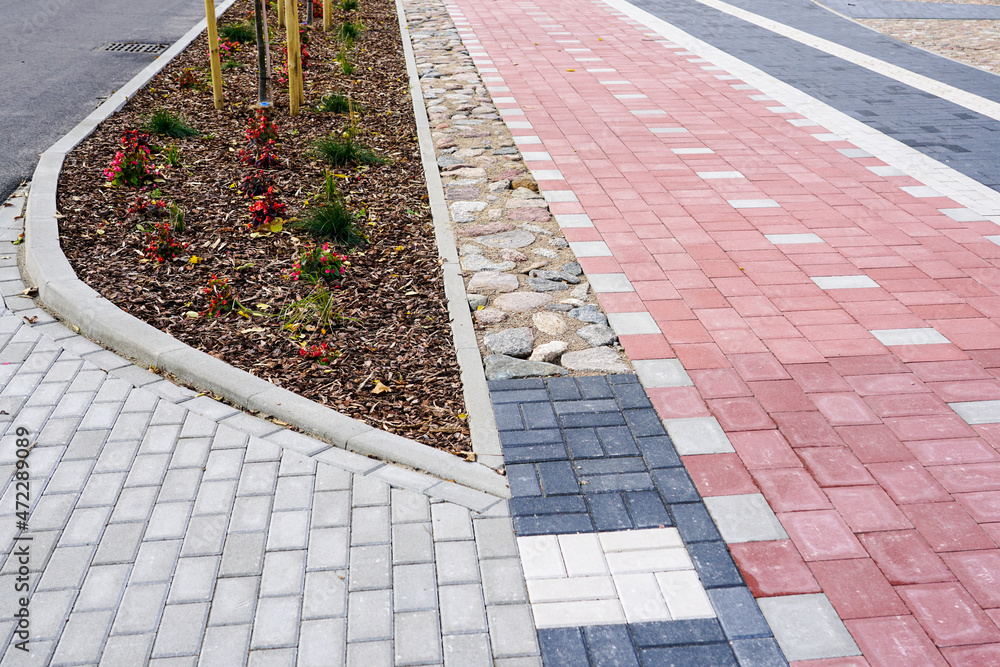 Fototapeta premium new colorful paved walkway with cobblestones of different colors