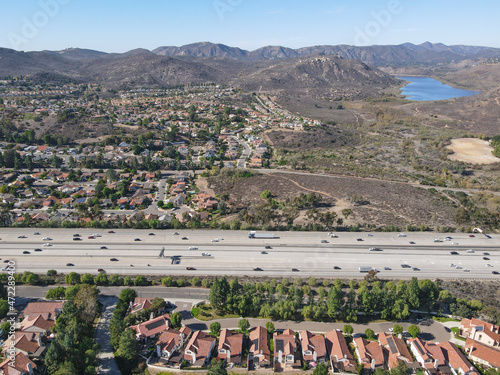 Aerial view of highway with traffic surrounded by houses, Interstate 15 with in vehicle movement. San Diego, California, USA.