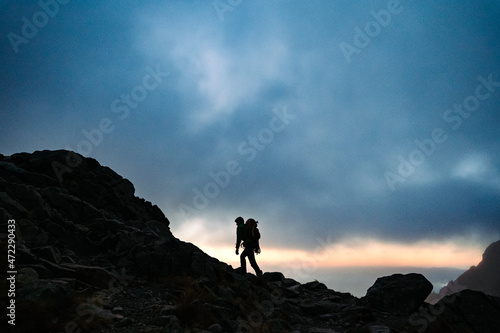 Alpinist Walking In The Mountains