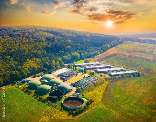Biogas plant and farm in fields. Renewable energy from biomass. Agriculture prepared for Green Deal. Aerial view to Czech industry. Sustainable development in European Union.  photo