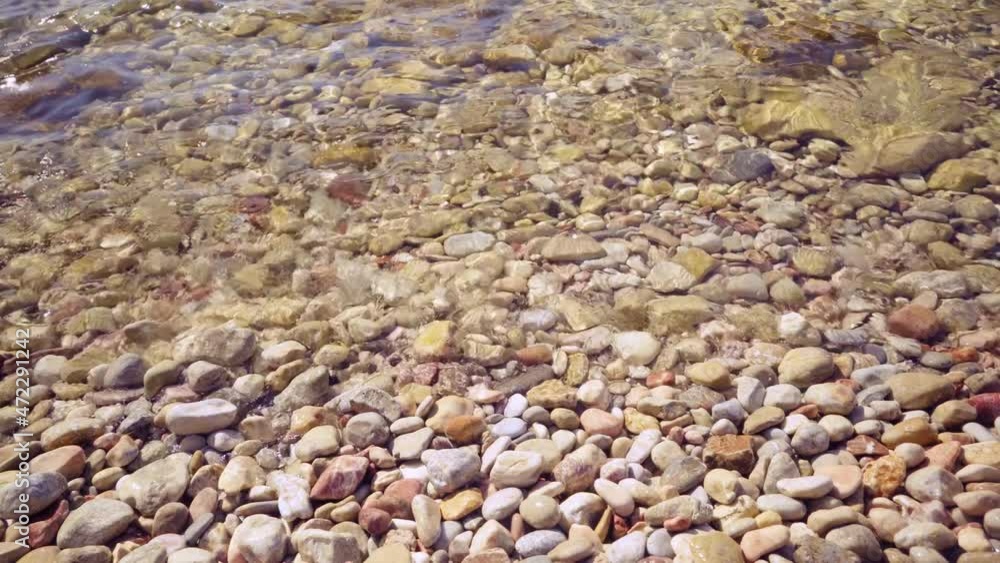 Shingle beach and relaxed waves of sea. Close-up Shingle beach and relaxed waves of sea. Close-up