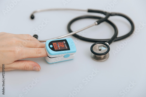 Stethoscope, pulse oximeter and thermometer gun on white background. Treatment of cold or flu. Phonendoscope. Infrared isometric thermometer gun to check body temperature for virus symptoms