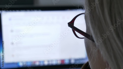 Woman looking for wok at LinkedIn as Java Script developer on laptop at home photo