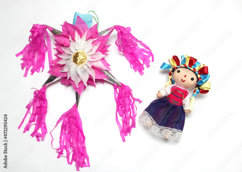 Naklejka premium Mexican handmade piñata of clay and colored paper to celebrate posadas and Christmas with doll, canes and poinsettia flowers 