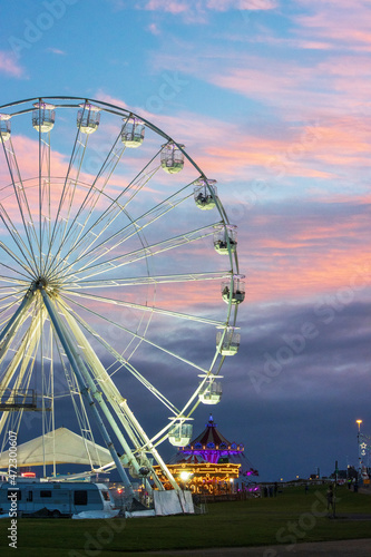 A beautiful sunset sky with a ferris wheel partially included.