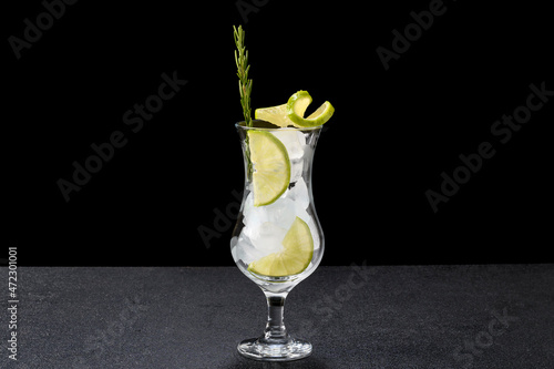 a glass with ice and lemon ingredients for cocktail and drink preparation