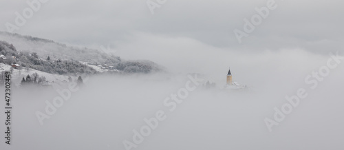 Winter in Croatia. Church. Fog. Snow