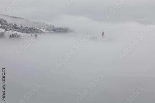Winter in Croatia. Church. Fog. Snow