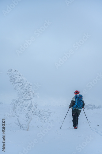 Woman skiing in cold conditions with frosty snow in Norway