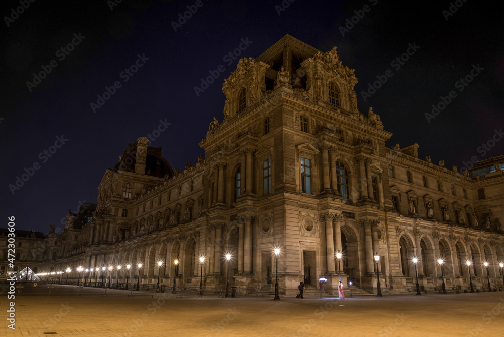 Beautiful facade of the Louvre Palace in Paris at night