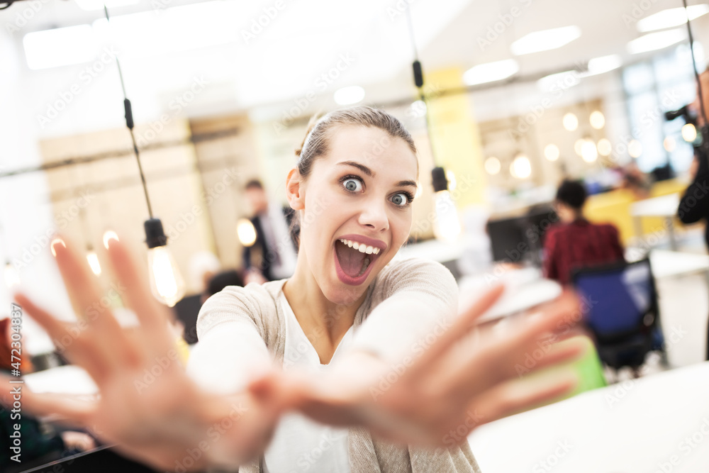 Cute blue eyed bussinss girl in a modern office space cheering. Successful work day excitement Cute blue eyed bussinss girl in a modern office space cheering. Successful work day excitement