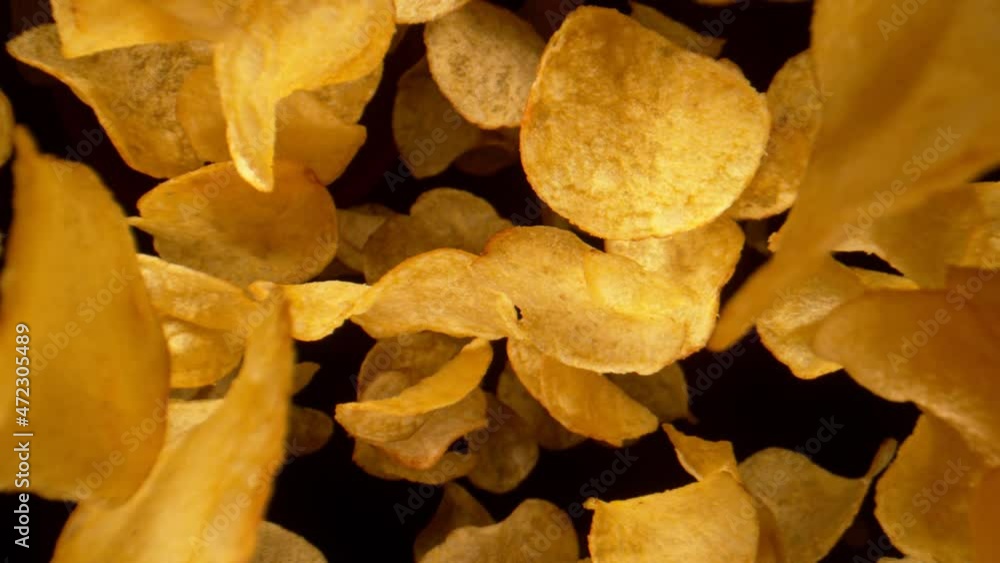 Super Slow Motion Shot of Potato Chips Flying Towards the Camera at 1000fps. Super Slow Motion Shot of Potato Chips Flying Towards the Camera at 1000fps.