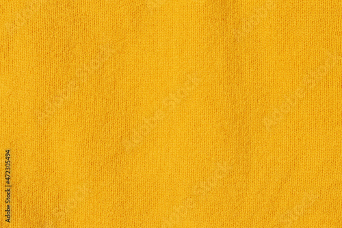 Knitted texture close-up, bright yellow color, background