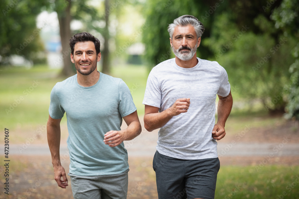 men jogging outdoor in nature - motion blur image panning men jogging outdoor in nature - motion blur image panning