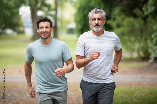 men jogging outdoor in nature - motion blur image panning photo