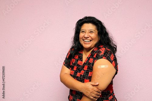 Body positive overweight adult laina woman shows her arm recently vaccinated against Covid-19 in the new normal for the Coronavirus pandemic
 photo