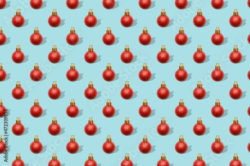 Christmas New Year holiday creative minimal seamless pattern green background with red baubles balls decorations, ornaments, Flat lay, top view