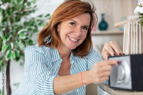 mature woman with radio at home