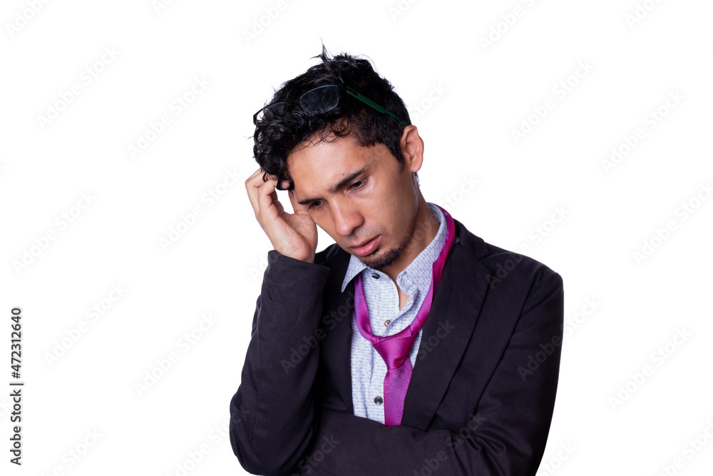 Businessman with a disheveled tie and deep in thought scratches his head while looking down. Young adult businessman isolated on all white background. Businessman with a disheveled tie and deep in thought scratches his head while looking down. Young adult businessman isolated on all white background.