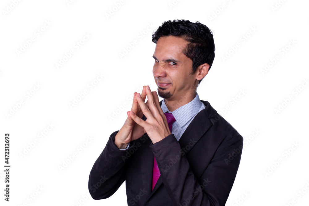 Bad man plans something evil. Businessman makes evil gesture by clasping his hands together and imitating Mr. Burns. Isolated on a totally white background. Bad man plans something evil. Businessman makes evil gesture by clasping his hands together and imitating Mr. Burns. Isolated on a totally white background.