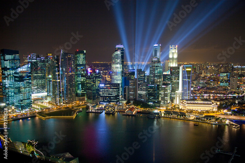Singapore. Searchlights and city building at night.