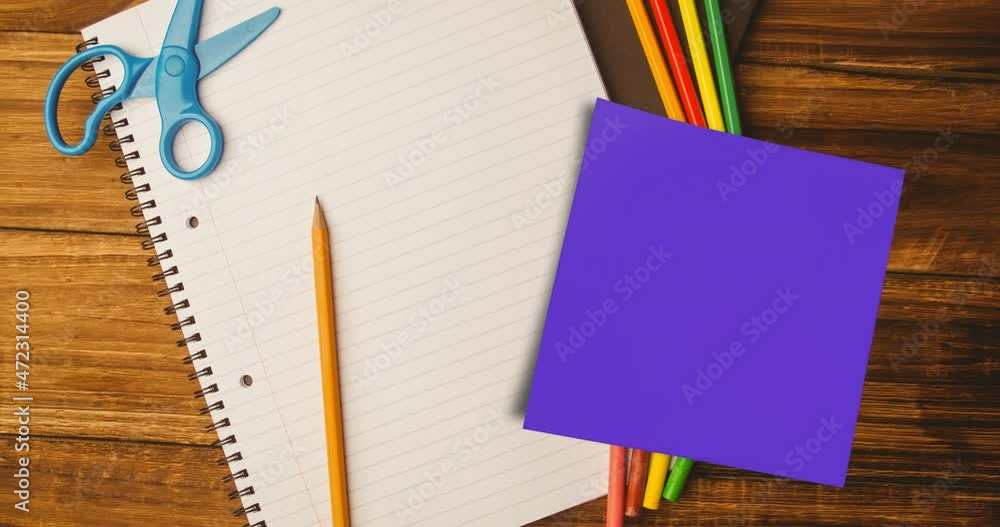 Animation of memo note with copy space over notebook and pencils on desk Animation of memo note with copy space over notebook and pencils on desk