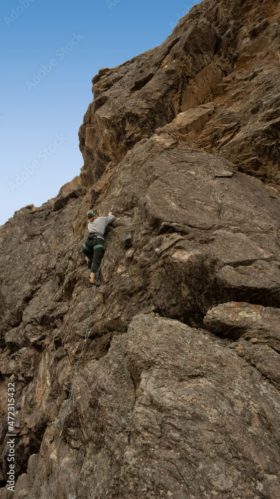 Women climbs a big cliff in Colorado Women climbs a big cliff in Colorado