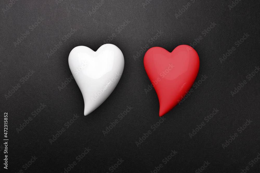 Fototapeta premium two hearts red and white on a black background, a symbol of love, the basis for the designer, wallpaper, gift wrapping, valentine's day background