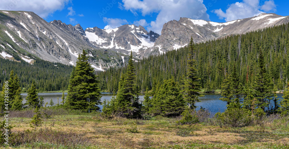 Indian Peaks at Long Lake - A panoramic view of rugged Indian Peaks at shore of Long Lake on a sunny Spring morning. Indian Peaks Wilderness, Colorado, USA.