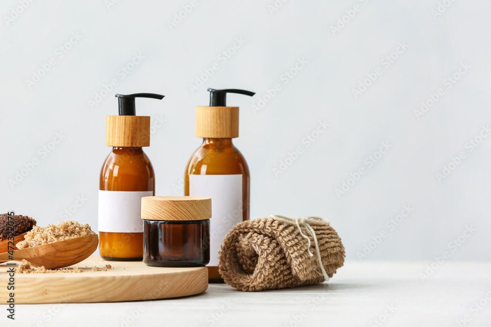Spa set with bottles of cosmetics on light background Spa set with bottles of cosmetics on light background