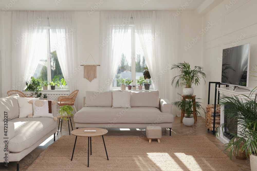 Stylish living room with comfortable sofas, modern TV and fireplace. Interior design Stylish living room with comfortable sofas, modern TV and fireplace. Interior design