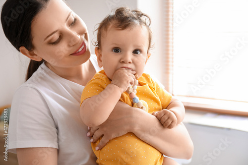 Young mother holding her li...