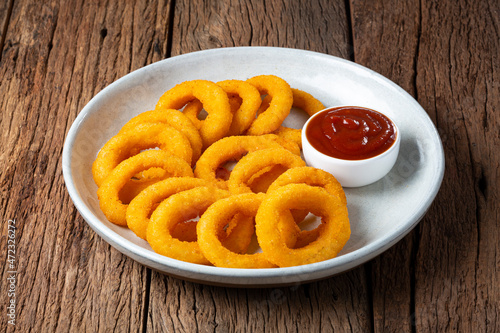 Crispy onion rings with ketchup. photo